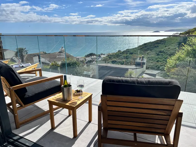 Balcony seating at Sunkeeper with panoramic sea views over Downderry